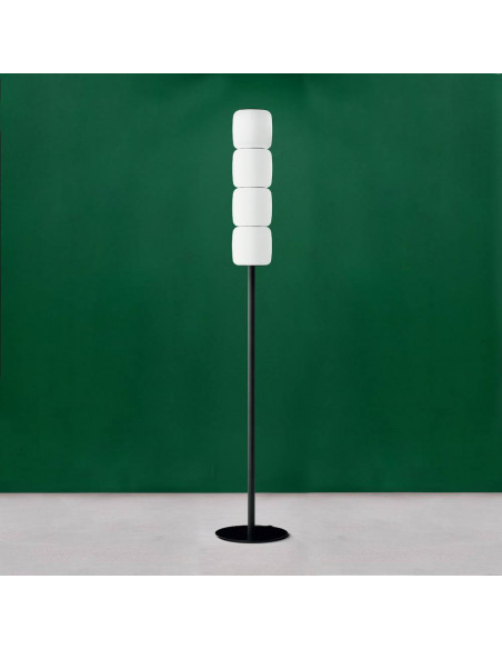 Design floor lamp in Murano glass with white satin lampshades on a green background Design floor lamp in Murano glass with white satin lampshades on a green background